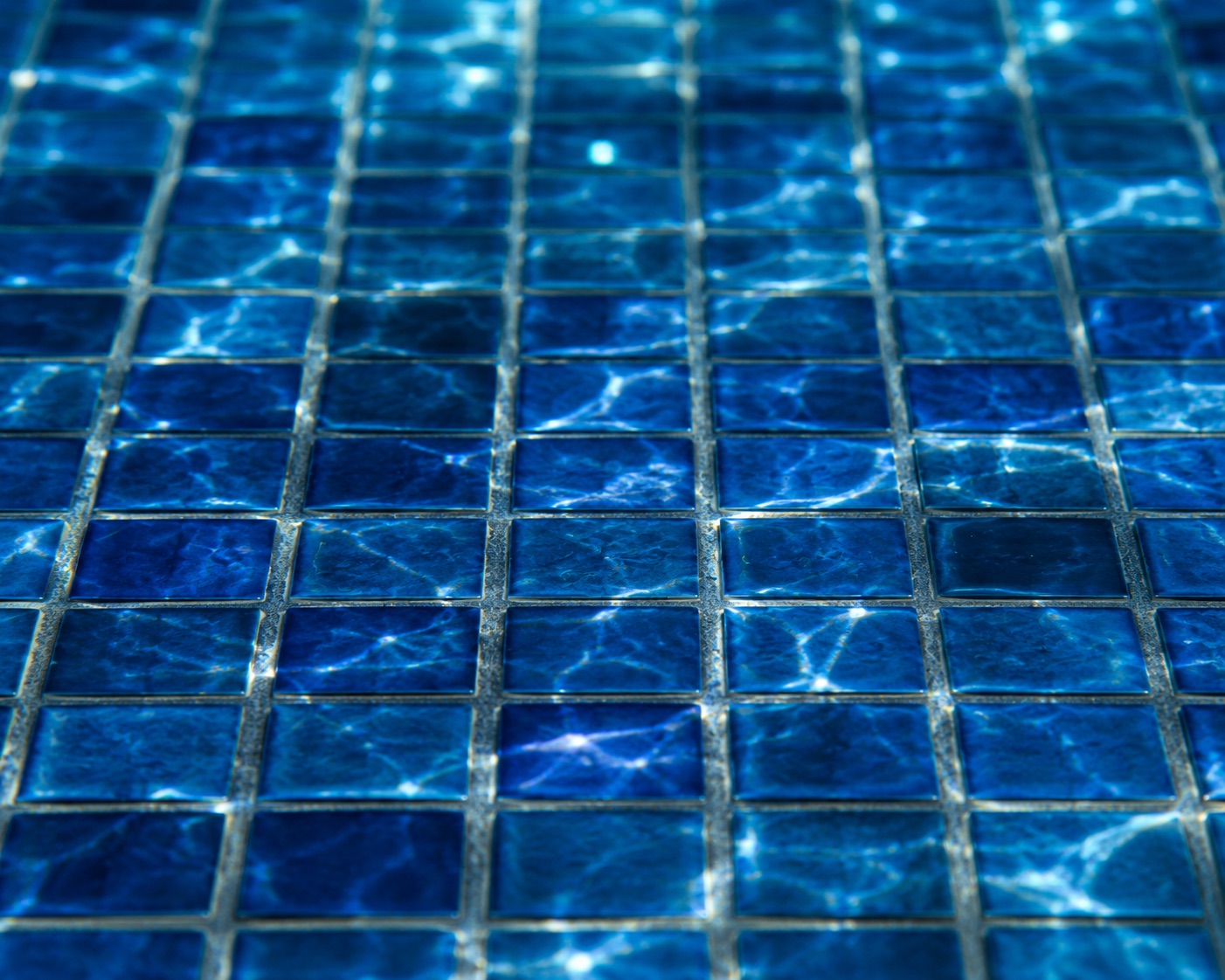 Flawless glass-mosaic pool tile detail — Al Kahaf pool care standard.